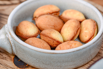 Traditional Georgian dessert. Cookies nuts with condensed milk and nuts served in a bowl on dark wooden table.