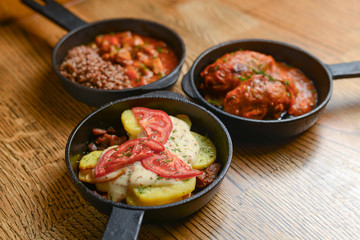 Table with traditional Ukrainian food, boiled buckwheat with meat gravy, meat and mushroom gratin, lazy cabbage rolls.