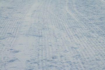 Fototapeta na wymiar Rribbed footprint in snow left snowcat.