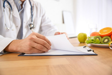 Nutritionist working at desk in office, closeup