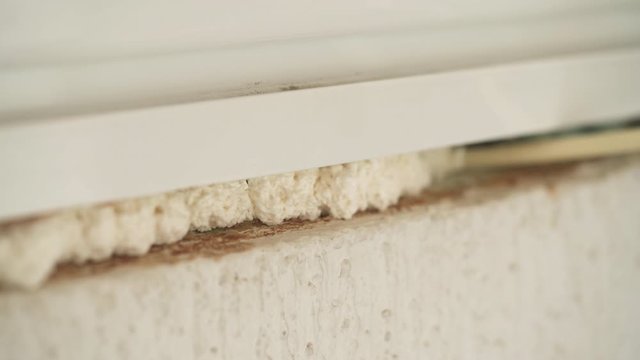 Using polyurethane foam to fill gaps during installing a window.