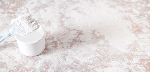 Paintbrush with white paint. Renovation