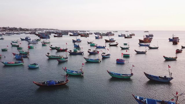 calm sunset over colorful fisherman boats at the bay of Mui Ne, Vietnam. South china sea