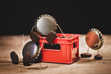 Crown cork miniature figures with a red beer crate