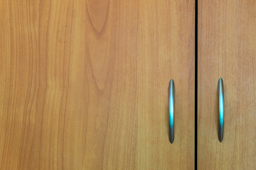 Fragment of a cabinet door with two handles. Minimalistic background.