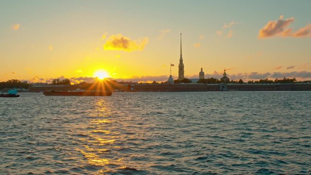 Beautiful sunset on the background of the Peter and Paul Fortress on the Neva River. St. Petersburg, Russia.