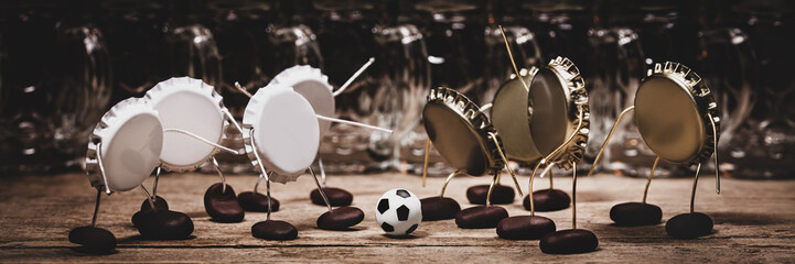 Crown cork miniature figures playing soccer, concept alcohol-free beer on sport events, header