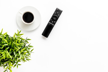 Television air recording concept. TV remote on white background top-down copy space