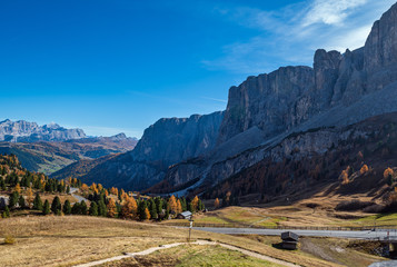Autumn alpine Dolomites mountain scene, Sudtirol, Italy. Peaceful view near Gardena Pass. Picturesque traveling, seasonal, nature and countryside beauty concept scene.