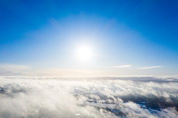 Aerial view clouds over forest. Aerial view of forest and clouds. Aerial drone view flying over the forest. Aerial top view cloudscape. Texture of clouds