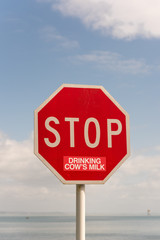 Traffic Stop sign altered, presumably by a vegan or vegetarian, with a sticker to read 