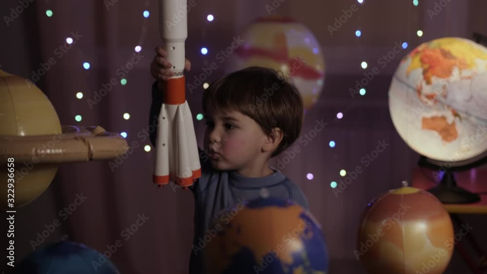 Wall mural space travel game inspiration spaceship. little kid boy astronaut launching toy rocket from spacepor