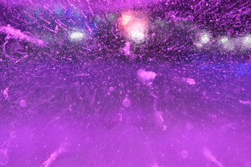 Abstract background of illuminated purple ice texture with air bubbles inside and backlights