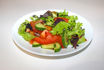 Green salad , organic kalamata olives, juicy tomatoes, red pepper, red onion, cucumber and lettuce. Concept for healthy nutrition. Tasty and healthy vegetarian meal. Close up.