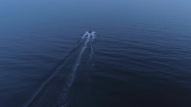 Aerial view of fast boat sailing on open sea