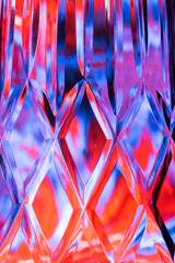 Abstract background of a bright colors through a diamond pattern lead crystal glass vase 