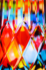 Abstract background of a bright colors through a diamond pattern lead crystal glass vase 
