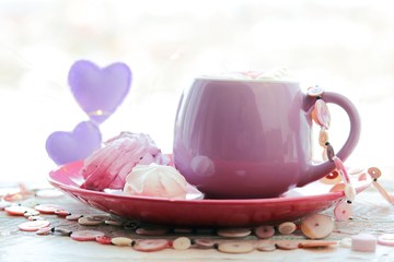 Cup of coffee with meringues and marshmallows, hearts, illumination on a wooden windowsill, home comfort, St. Valentine's Day