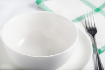 Ceramic white tableware for soup on the table. Close up view.