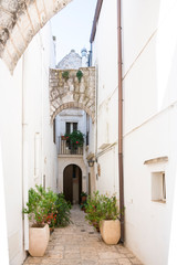 Fototapeta na wymiar small street in historical white town Locorotondo, Italy