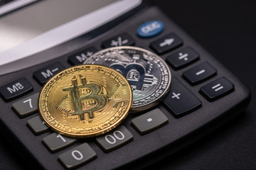  Bitcoin coin on calculator  isolated on black background