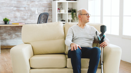 Revealing shot of male nurse checking on retired old man with alzheimer