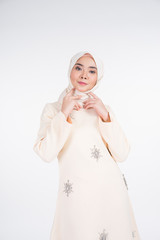 Beautiful female Muslim model in various poses wearing kurung Pahang and hijab, a lifestyle apparel for Muslim women isolated on white. Beauty and hijab fashion concept. Half length portrait