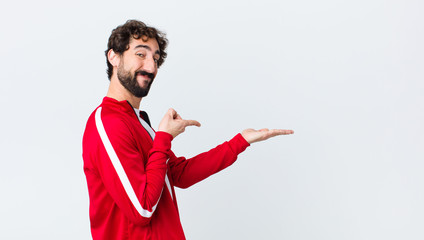 young bearded man back view smiling cheerfully and pointing to copy space on palm on the side,...