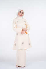 Beautiful female Muslim model in various poses wearing kurung Pahang and hijab, a lifestyle apparel for Muslim women isolated on white. Beauty and hijab fashion concept. Full length portrait