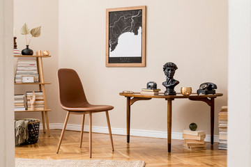 Stylish interior design of private library room with mock up poster map, brown chair, wooden table, bookstand, books and elegant personal accessories. Retro vintage home decor. Beige wall. Template. 