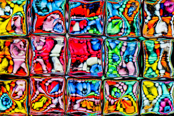 Abstract background of a colorful image distorted through a glass block wall