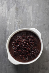 boiled black beans in white bowl on ceramic background