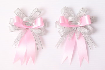 Pink and silver bow isolated on white background.
