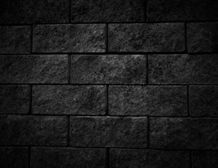 Black wall as background, texture of a black brick wall.The texture of stone.