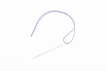 Sewing needle with blue thread on the white background