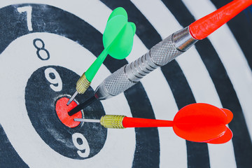Dart arrow hitting in the target center of dartboard for background Target, business, achieve and...