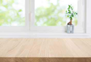 Empty wood table top and blur window interior abstract background