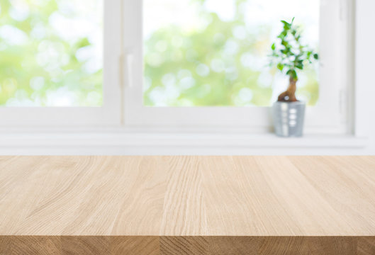 Empty wood table top and blur window interior abstract background
