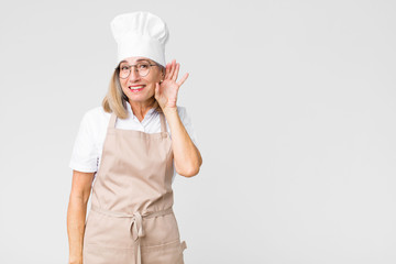 middle age baker woman smiling, looking curiously to the side, trying to listen to gossip or...