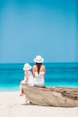 Beautiful mother and daughter at the beach enjoying summer vacation. © travnikovstudio