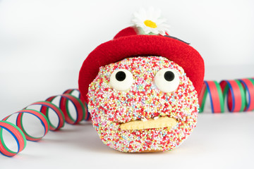 Funny face cake with red hat and streamer, white background