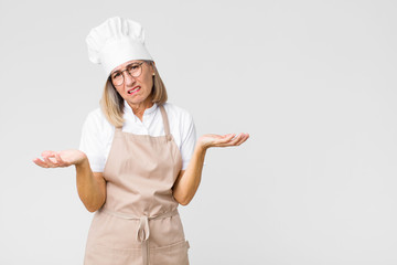 middle age baker woman feeling clueless and confused, not sure which choice or option to pick,...