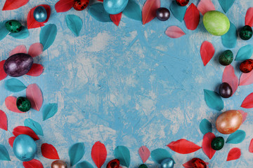 Easter decorative frame on the blue textured background. © Natalia