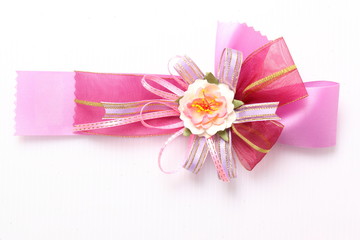 Fototapeta na wymiar Red and pink satin gift bow. Ribbon. Isolated on white