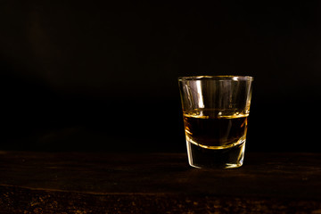 Amber whisky on dark background.