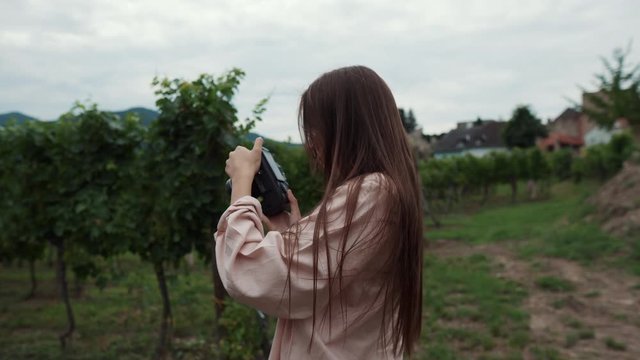 Girl capturing vineyards in Wachau Valley, Austria