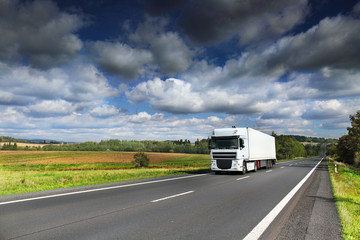 Fototapeta na wymiar White truck transport on the road and cargo