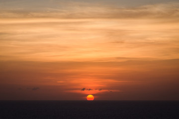 Sun setting over the sea in Bali with an orange sky