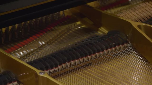 View of pressed pedal inside piano.