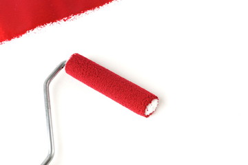 red paint and painting roller on white background